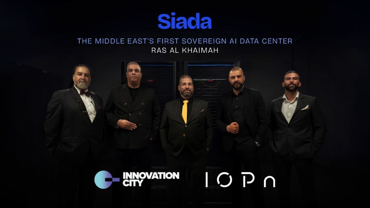 IOPn and Innovation City executives standing inside Siada’s sovereign AI data center in Ras Al Khaimah, with data servers and company logos in the background.